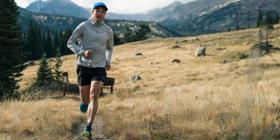 Team Injinji ultrarunner Athony Lee running on a single track trail.