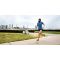 Elite athlete Mike Wardian running down a large sidewalk with the city line in the background.