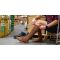 A person sitting in a warehouse surrounded by cardboard boxes adjusting their Injinji Boot Original Weight OTC socks.