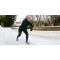 Kati Keenan in running position on the bank of a snowy running path.