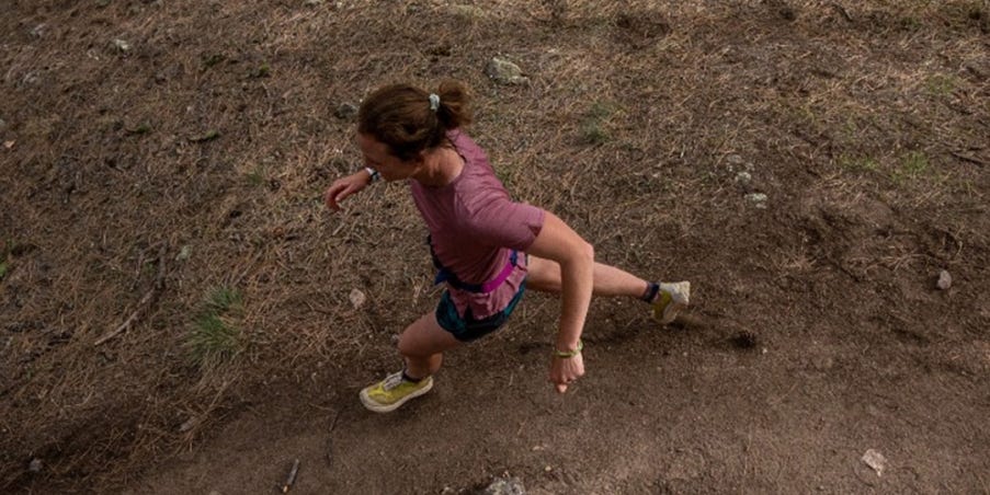 Team Injinji Athlete Alyssa Clark running on a trail.