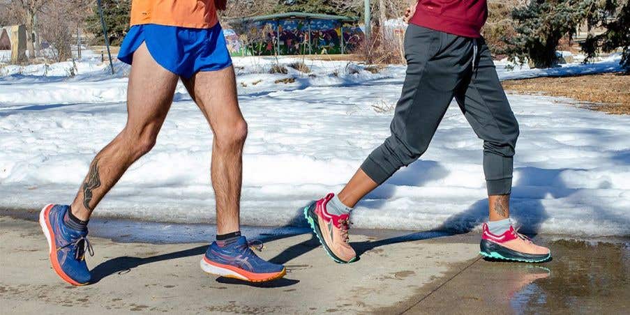 Two people running in winter at a park wearing Injinji socks.