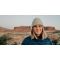 Kika McFarlane standing in front of desert mesas in Moab, Utah.