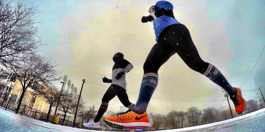 Lindsey and Kati running together outdoors.