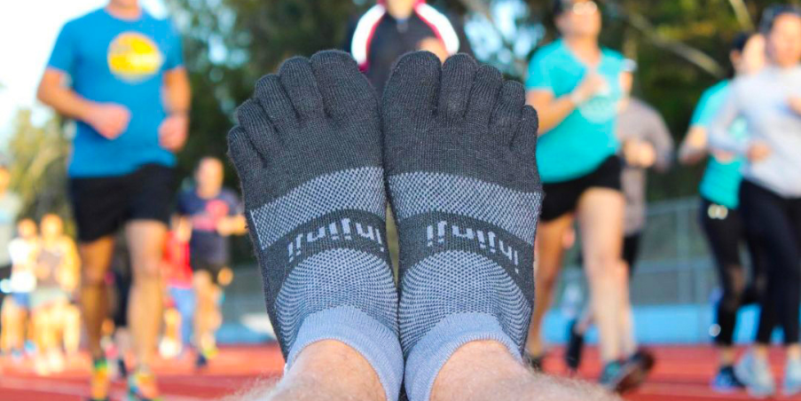 Top view of Injinji Run Midweight Mini-Crew socks at a running track.
