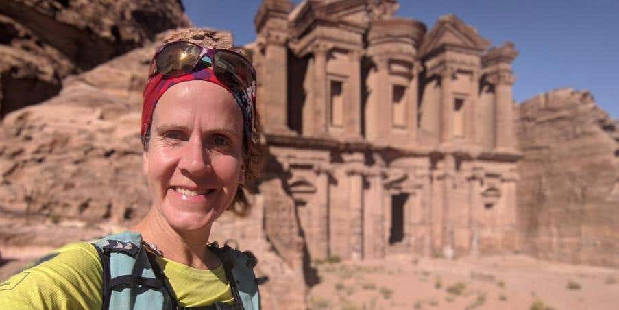 Amy Sproston in Jordan with ancient architecture in the background