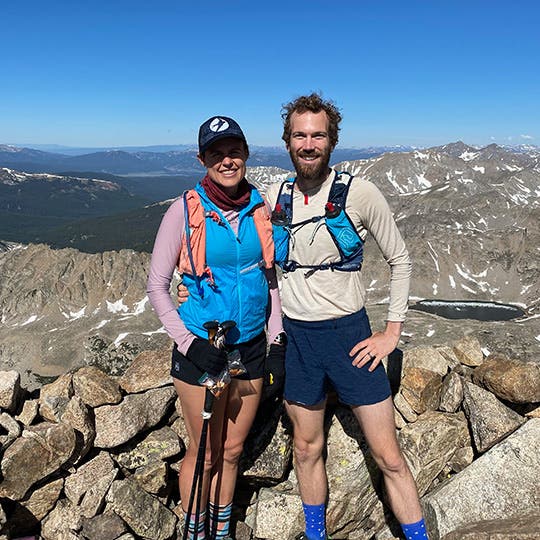 Pregnant Cate Barrett with a partner hiking in the mountains of Colorado