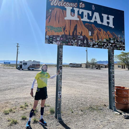 Mike posing in front of the Utah Welcome sign. 