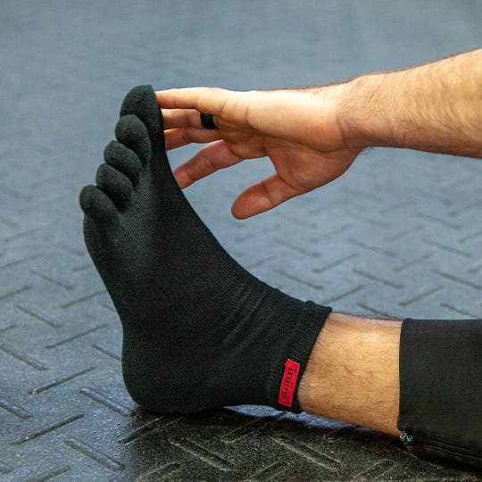 Model stretching in the Sport Original Weight Mini-Crew in Black.