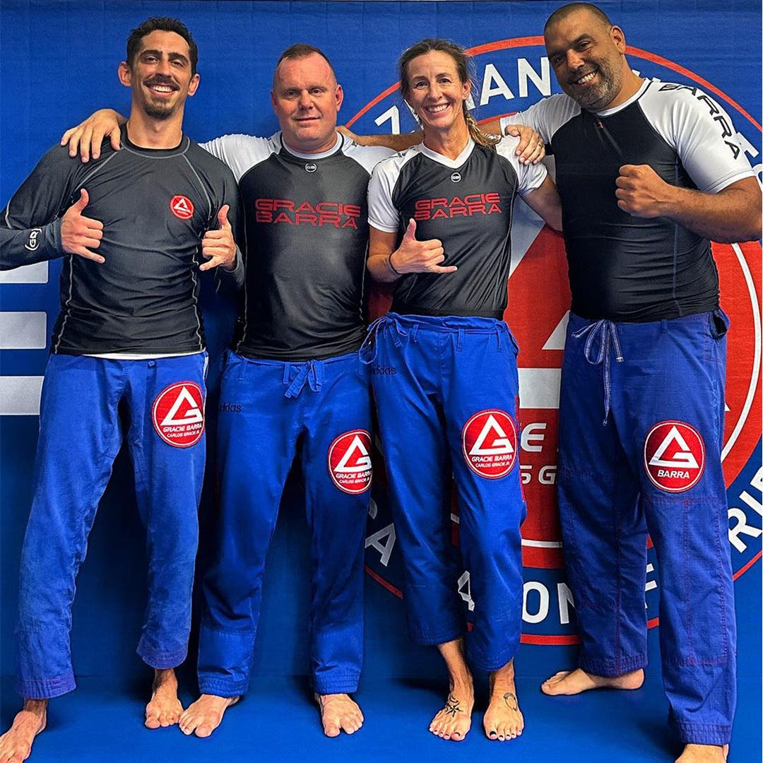 Karin Bachrodt posing with three of her Brazilian jiu-jitsu teammates. 