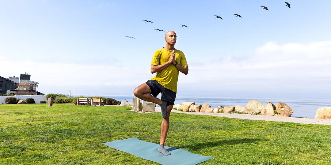 A person practicing yoga outdoors wearing Injinji Grip Full Foot No-Show socks.
