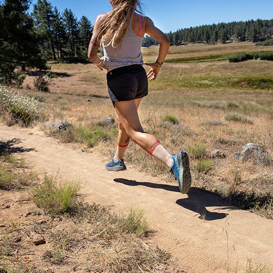Woman Running On A Trail Woman Running On A Trail