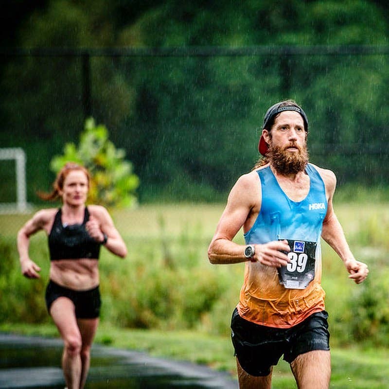 Mike Wardian running hard during a race in the rain.