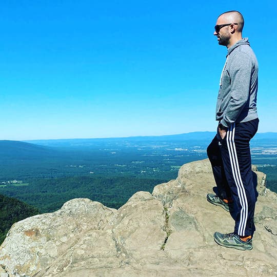 Joe Dean overlooking a cliff off a trail. Joe Dean overlooking a cliff off a trail.