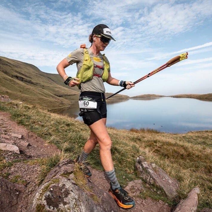 Team Injinji athlete Anthony Lee jumping at the finish line of Ultra Trail du Mont Blanc.