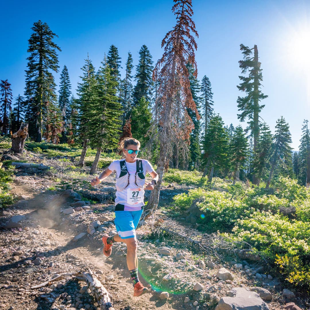 Team Injinji athlete Courtney Dauwalter running downhill at Western States 100 ultramarathon.