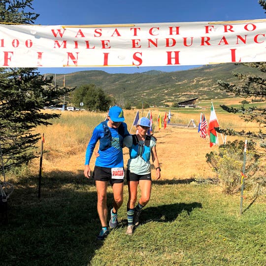 Francesca Conte walking in the mountains with James Russell Gill III