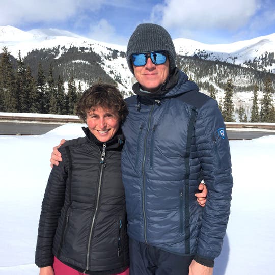 Francesca Conte standing besides James Russell Gill III surrounded by a snowy landscape