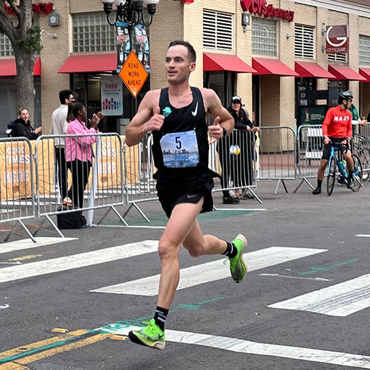 Dylan Marx races the San Diego Half Marathon while fans and bystanders watch. Dylan Marx races the San Diego Half Marathon while fans and bystanders watch.