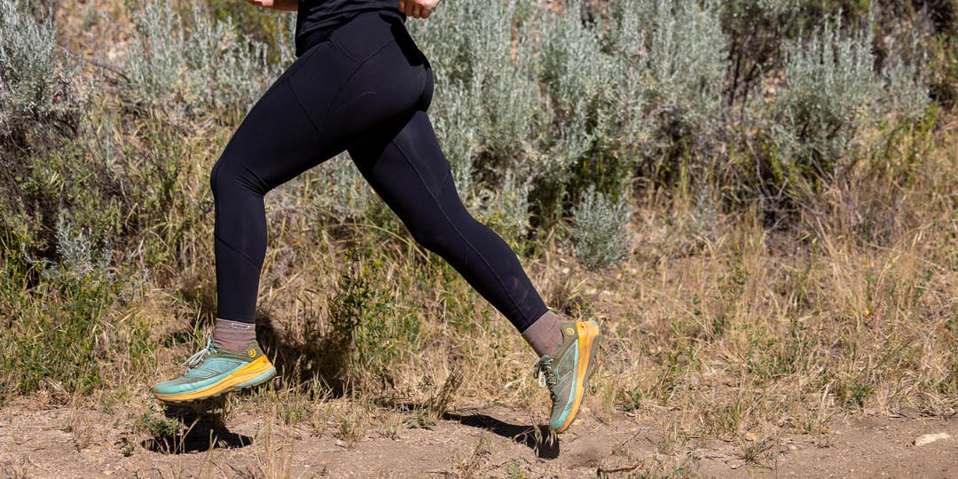 A woman running on the trail wearing Injinji socks.
