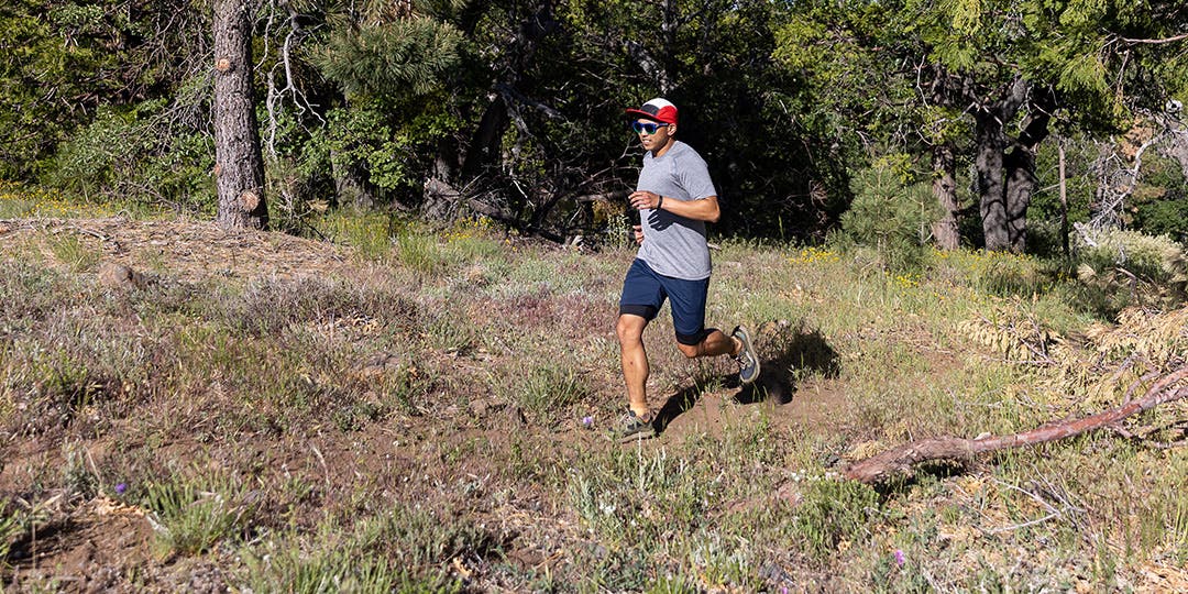 A man running on the trail wearing Injinji socks.
