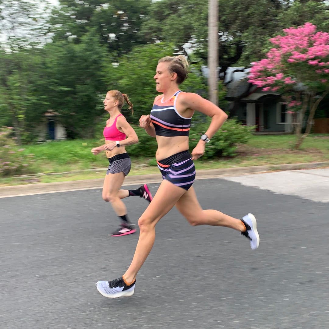 Cate Barrett running with a friend on a suburban road in the early stages of her first pregnancy.