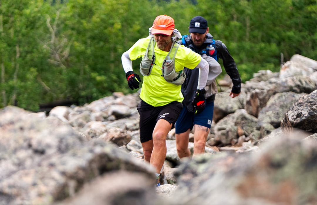 Coach Jeff Browning and one of his support pacers running through a boulder feild on his record setting FKT of the Colorado Trail.