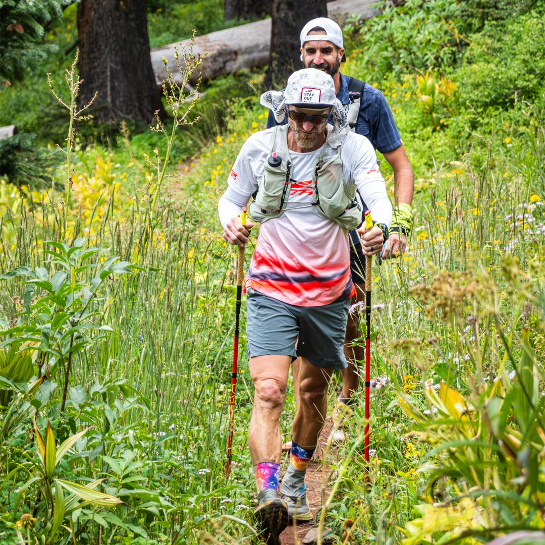Jeff Browning and his pacer running with hiking poles, while wearing the Injinji Courtney Crew in Hardrock.