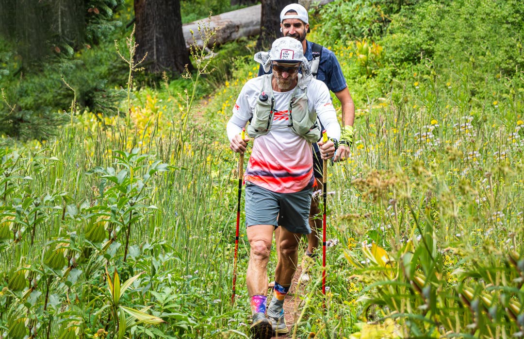 Jeff Browning and his pacer running with hiking poles, while wearing the Injinji Courtney Crew in Hardrock.