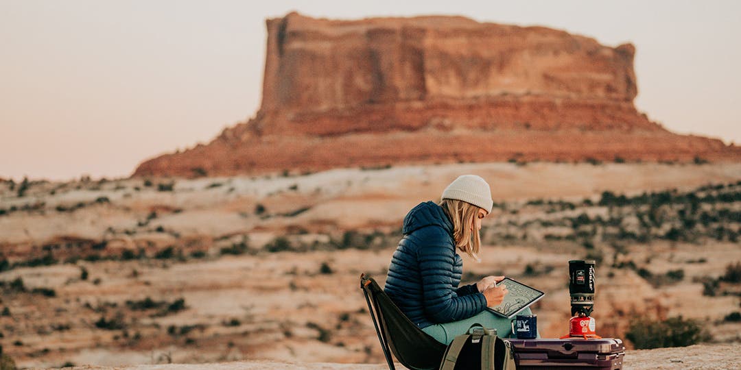 Artist Designed Canyons Collection artist Kika MacFarlane drawing at her camping spot in the desert of Moab, Utah.  