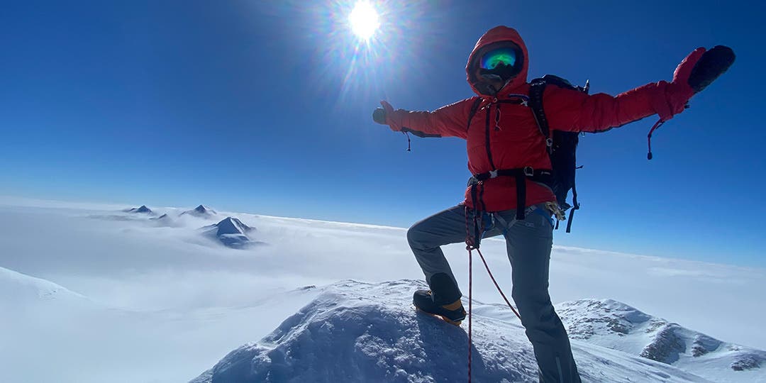 Team Injinji Athlete Meghan Buchanan dressed in full ice mountaineering gear at the top of one of the Seven Summits.