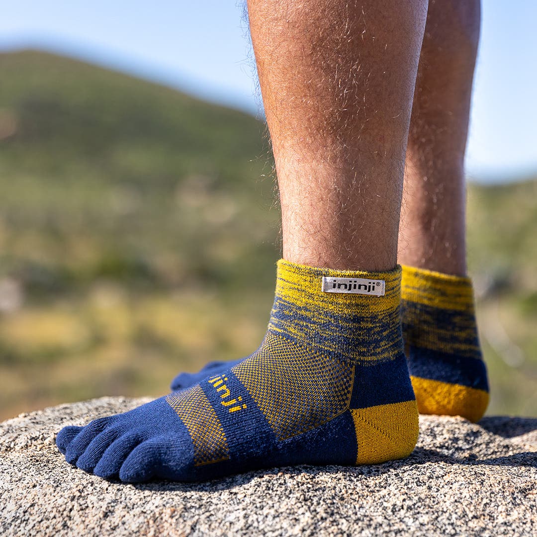 Close up of a hiker's feet with Injinji Trail Midweight Mini-Crew socks on.