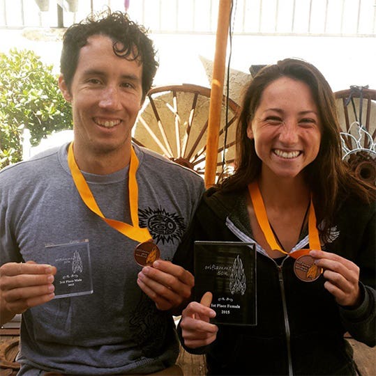 Jade Belzberg with her husband, holding up their medals and trophies