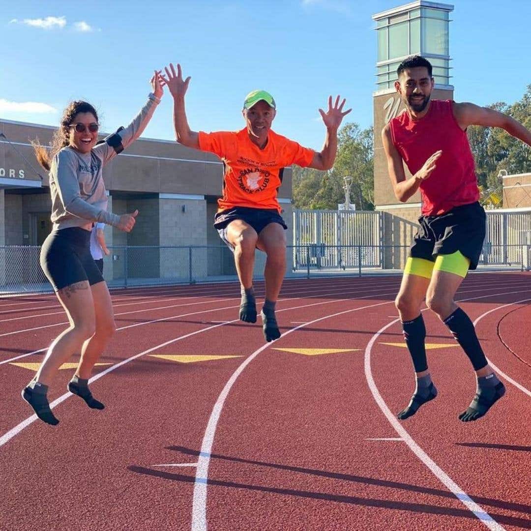 San Diego Track Club members at the SDTC track jumping into the air. 