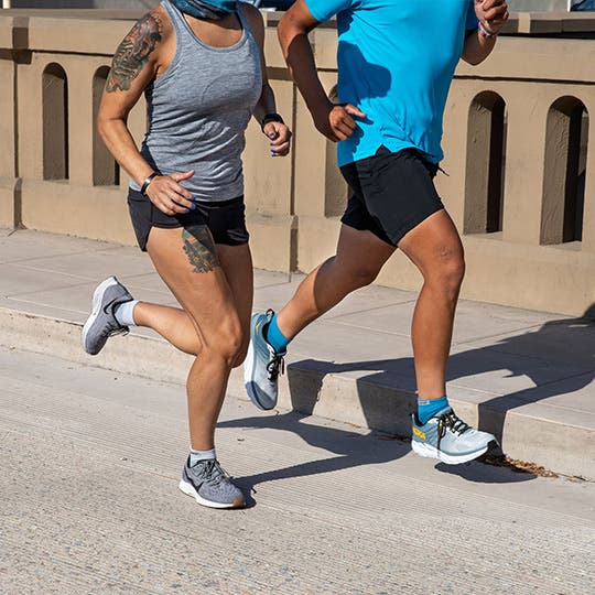 A man and woman road running in Injinji mini-crew toesocks. A man and woman road running in Injinji mini-crew toesocks.