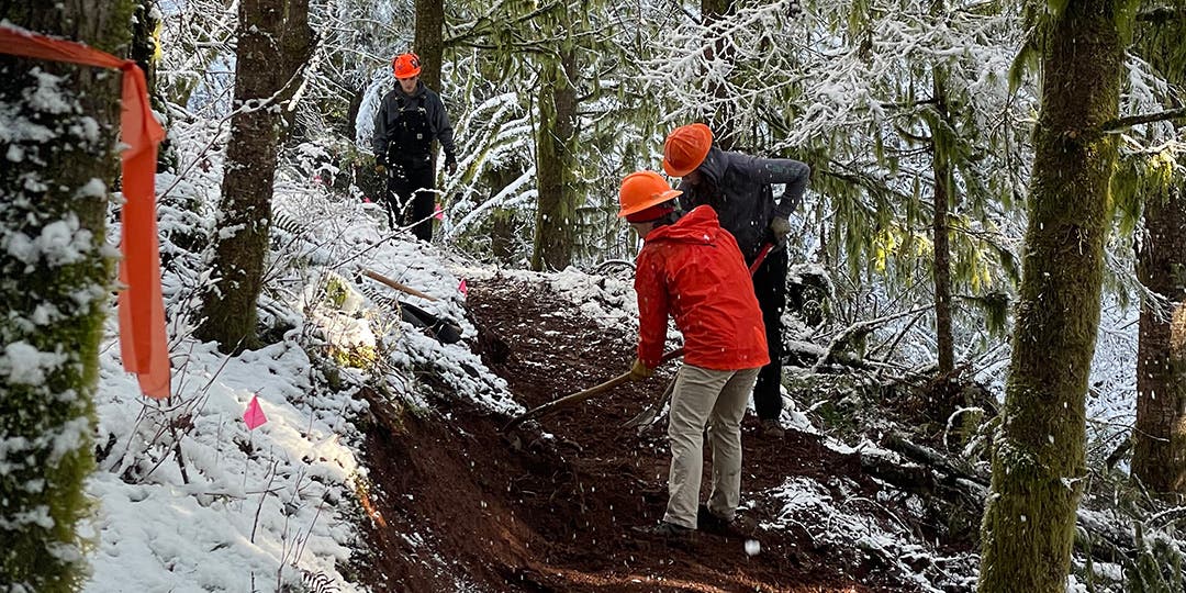 Andrew Miller and the other volunteers doing trail work on a snowy trail. 