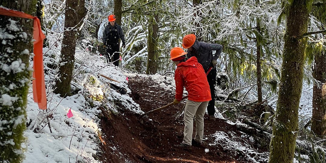 Andrew Miller and the other volunteers doing trail work on a snowy trail.