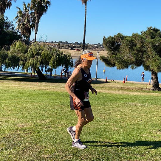 Virginia Lopez running through some grass in San Diego. 