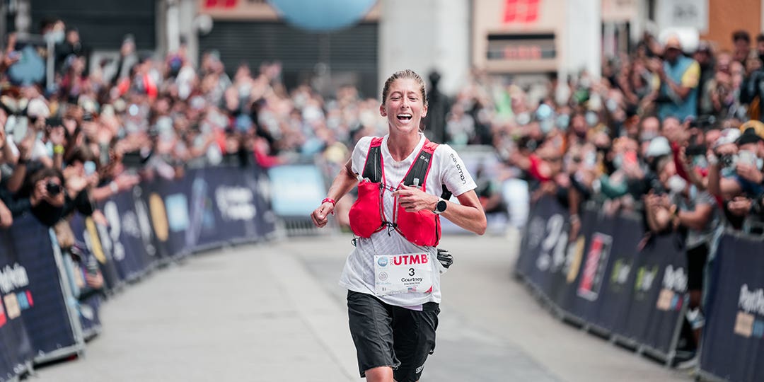 Courtney Dauwalter at the finish line of UTMB race cheered up by the crowd