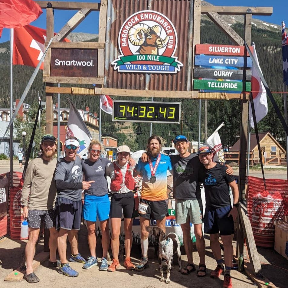 Mike Wardian posing for the camera with his friends and pacers at the finish line of the Hardrock 100 race.