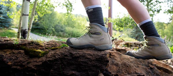 Person hiking up boulder