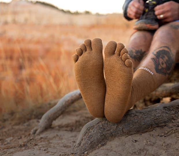 A backpacker wearing the Injinji Liner Crew in Elk
