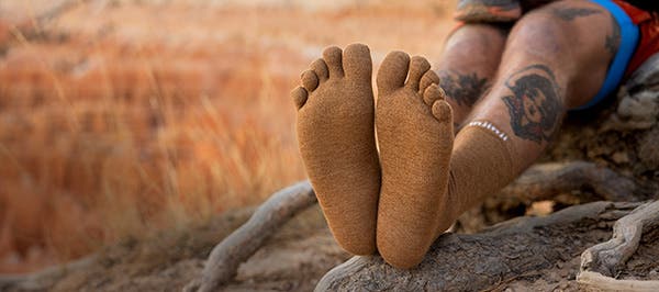 A backpacker wearing the Injinji Liner Crew in Elk