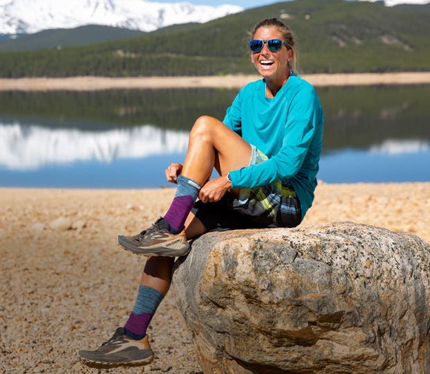 Courtney Dauwalter pulling on Injinji Crew socks.