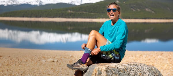 Courtney Dauwalter pulling on Injinji Crew socks.