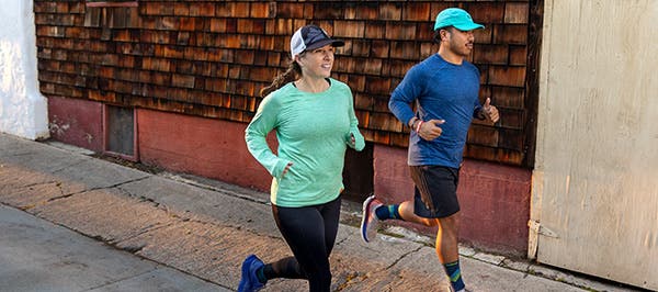 Two runners in the new Injinji Performance Shirt Collection short and long sleeve shirts.