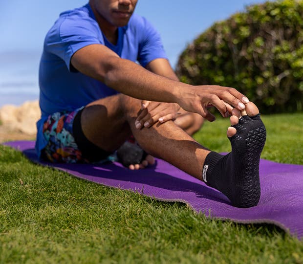 A person Wearing Injinji x Pointe Studio grip socks