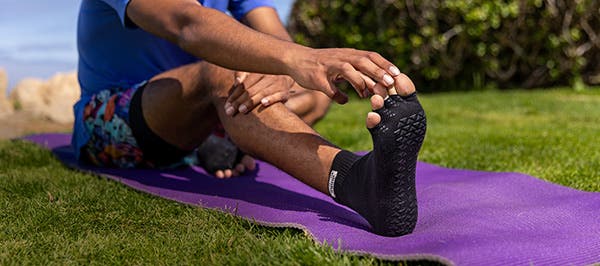 A person Wearing Injinji x Pointe Studio grip socks
