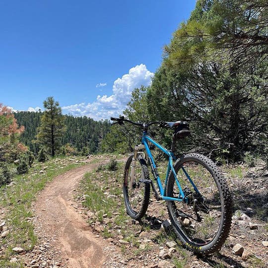 Blue bike standing on the mountain trail