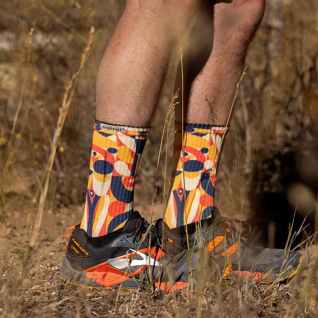 A person's legs and feet wearing the Artist Designed Men's Crew sock in Foothill.